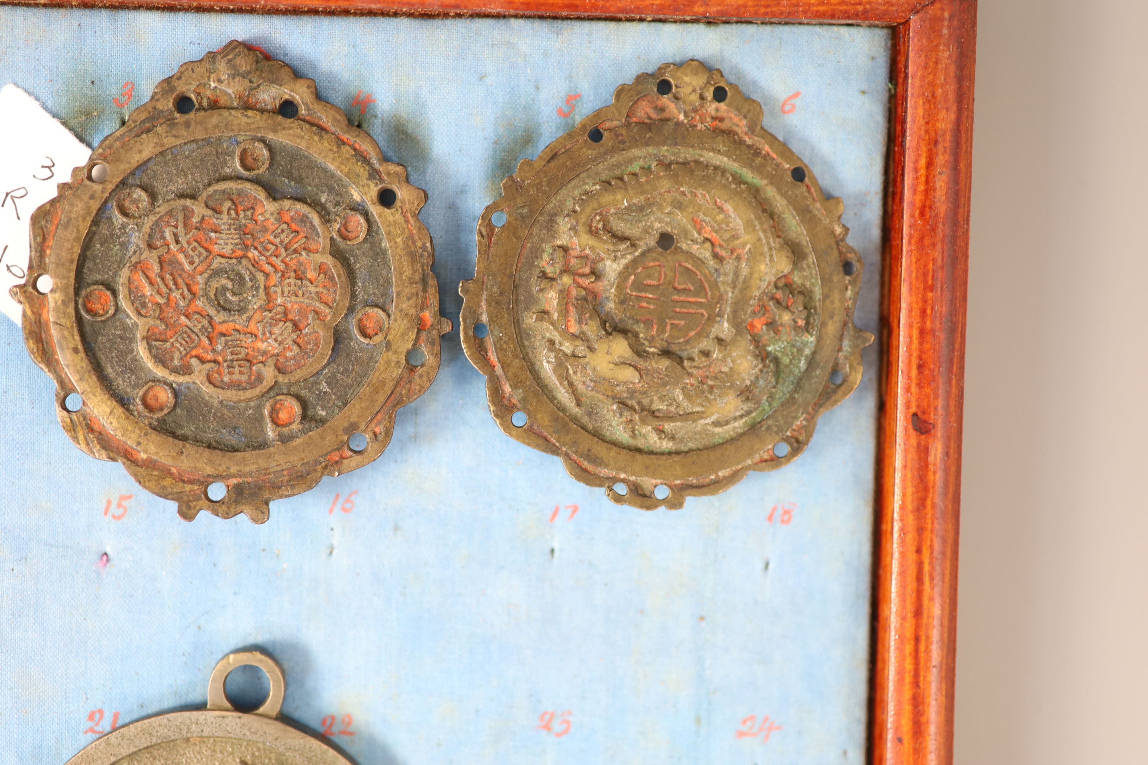 A group of 99 Korean bronze and metal amulets or charms, 19th/20th century